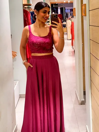 A mirror selfie in a vibrant magenta co-ord set, a perfect example of a modern festive outfit.