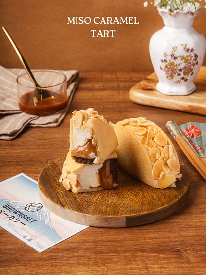 Our Miso Caramel Tart, a standout from The Japan Edit, offering a unique blend of sweet and savory flavors with a crunchy almond topping.