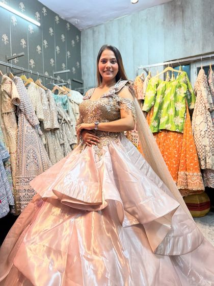 A full view of our tiered satin gown. The structured skirt creates a dramatic silhouette, and the hand-embroidered bodice adds a touch of luxury.