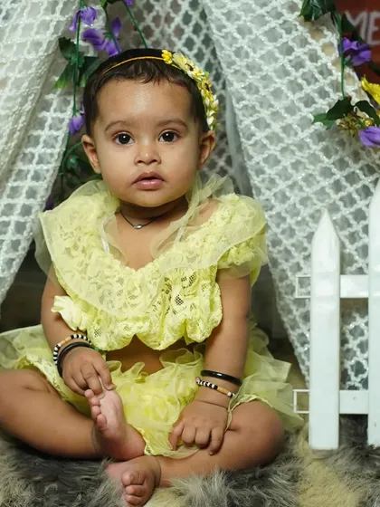 A close-up from a tent-themed photoshoot. The soft lighting and gentle colors are perfect for capturing the sweet expressions of a toddler.