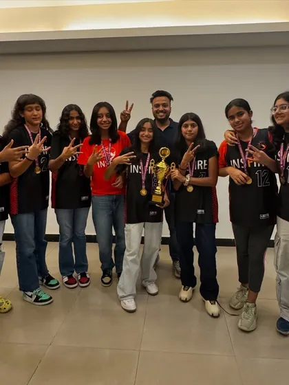 The team and their coach celebrating a well deserved victory. These moments build bonds that last a lifetime.