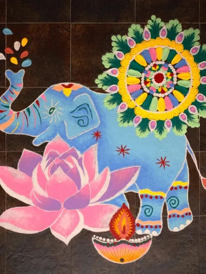 A vibrant and elaborate powdered rangoli featuring an elephant and a lotus, created for a Diwali collaboration with Google Arts & Culture.