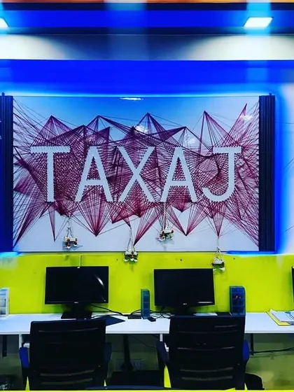 The heart of our office, featuring our custom "TAXAJ" string art. This represents the interconnected nature of financial compliance and how we tie everything together for our clients.