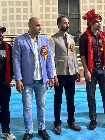 Standing with fellow officials and guests at the Delhi state boxing championship.