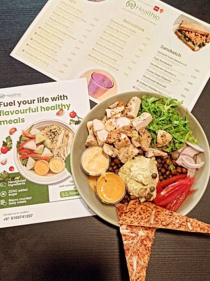 Fuel your life with flavorful, healthy meals. This shot features our Mexican Chicken Bowl alongside our menu, showing the variety of delicious and nutritious options we offer.