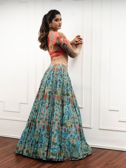 Discover the beauty of traditional craftsmanship with this stunning Pen Kalamkari lehenga. The piece is meticulously hand-painted by my artisans, with a story unfolding on the blouse sleeves and a beautiful floral pattern on the skirt and dupatta.