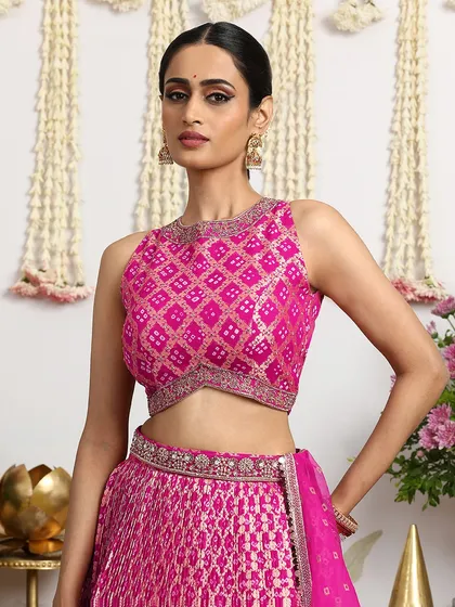 The intricate Bandhani pattern on this fuchsia blouse is a testament to the masterful skill of our artisans. It is a piece that celebrates the rich heritage of Indian textiles.