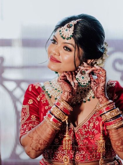 A close-up of our prettiest bride getting ready. The focus is on her radiant skin and the beautifully detailed jewellery she is putting on.