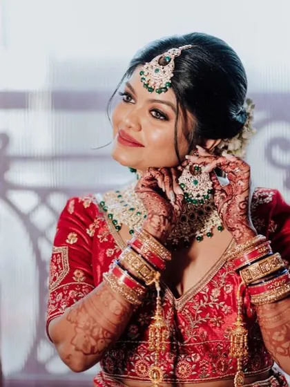 A close-up of our prettiest bride getting ready. The focus is on her radiant skin and the beautifully detailed jewellery she is putting on.