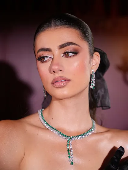 A soft, elegant portrait that captures the luminous quality of the makeup.