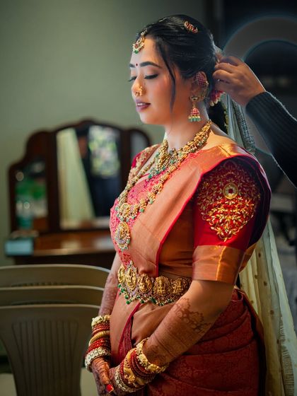 A behind-the-scenes shot of the final touches to her hair, her makeup already looking flawless.
