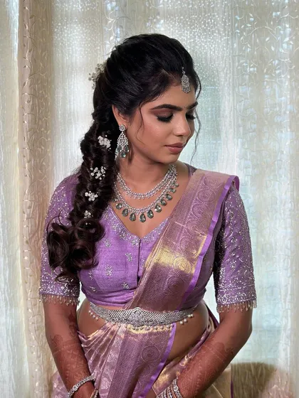 A candid, downward glance highlighting the intricate hairstyle and diamond jewellery.