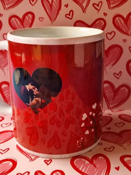 The other side of the custom mug, showing a photo inside a heart-shaped frame against a romantic red background.