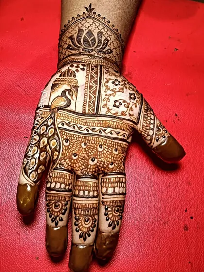 An elegant mehendi design featuring a peacock in a window frame, surrounded by delicate floral and traditional Indian patterns.