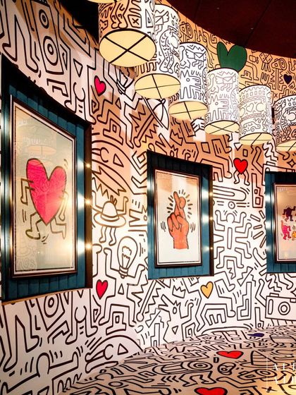 For the pre-dining area, I created a tribute to Keith Haring's iconic doodle style. The walls and custom lampshades were covered in his signature black-and-white figures, accented with pops of color from framed prints, creating a high-energy, graphic space.