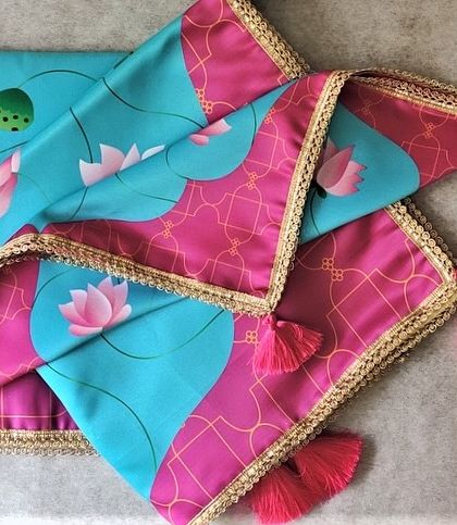 This modern and vibrant antarpat features a beautiful lotus print on turquoise and pink fabric. The gold lace border and bright tassels make it a cheerful and stylish choice for a contemporary wedding.