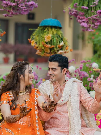 A candid shot of the couple dancing and laughing together at their Mehendi party.