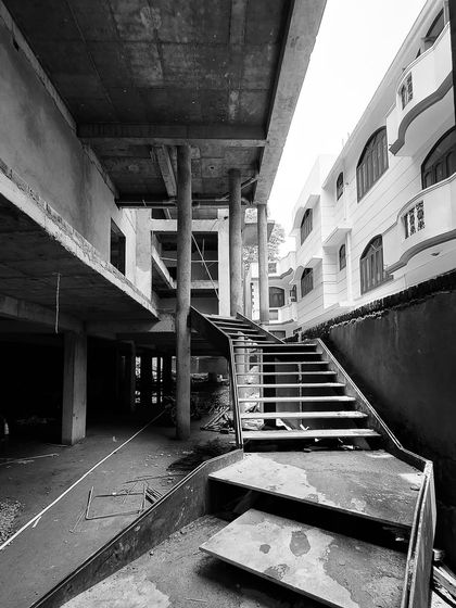 The raw form of a sculptural metal staircase at one of our Gurugram projects. This image, taken during construction, highlights the strong design intent and structural planning that our team manages from start to finish.