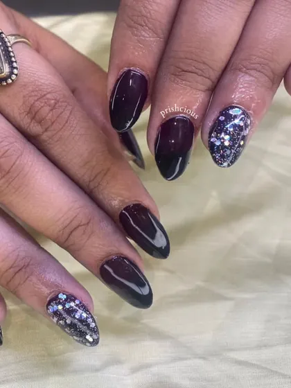 A dramatic black and silver glitter ombré on long almond-shaped acrylic extensions. This is such a glam and edgy look.