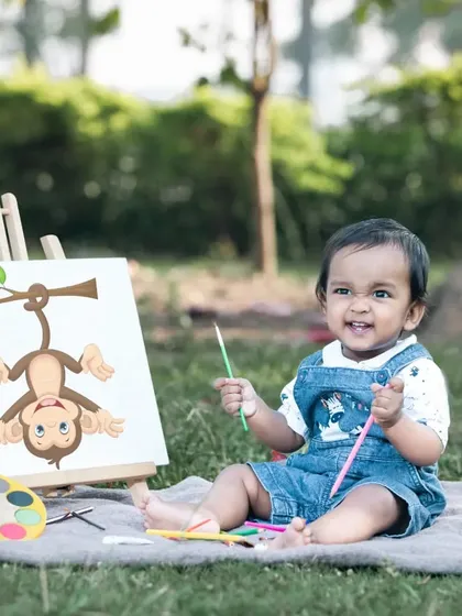 This little painter is having so much fun with his monkey-themed art project.