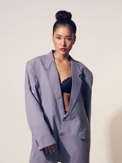 The full look, where the oversized blazer and lace bralette are paired with a fresh, dewy makeup look for a modern, sophisticated vibe.