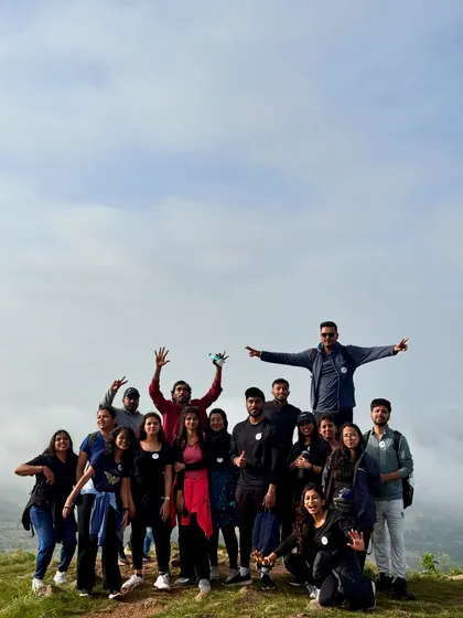A fun group photo at the top of Uttari Betta. These quick getaways are great for team outings and making new friends.