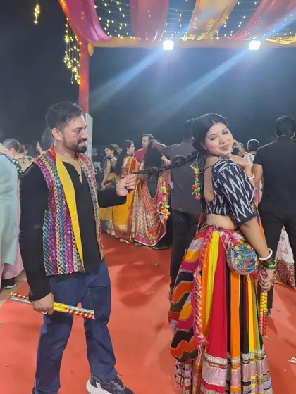 A playful moment during a Garba night in Delhi. The festive season is our favorite time of the year, filled with colorful ethnic wear, dandiya sticks, and non-stop dancing.