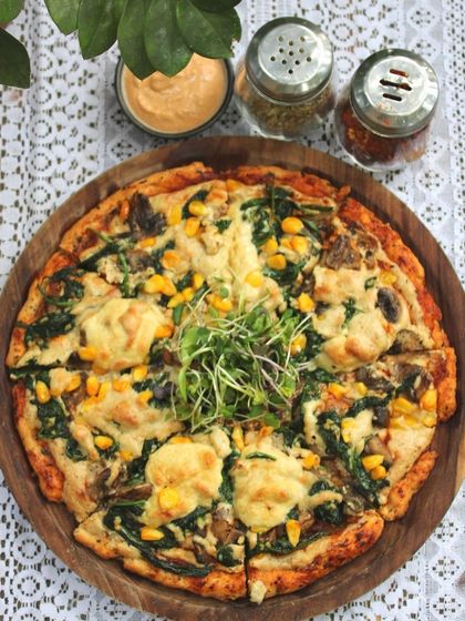 Our 'Earth Song Pizza' is a handcrafted thin-crust pizza topped with our in-house tomato sauce, B12-rich mushrooms, iron-packed spinach, and creamy vegan burrata cheese. It's an explosion of flavors you won't want to miss.