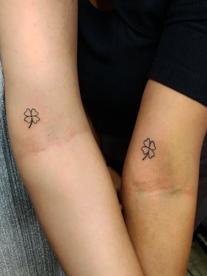 Matching four-leaf clover tattoos for two friends. A simple and sweet way to wish each other good luck and celebrate their friendship.