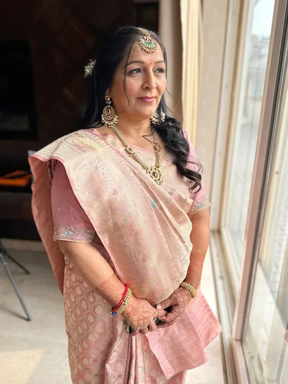 A lovely, candid shot. The makeup is designed to look natural and radiant, enhancing her graceful features.