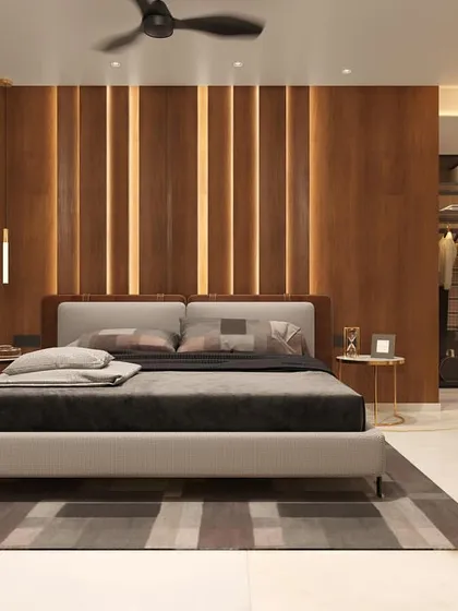 A contemporary bedroom design featuring a floor-to-ceiling wood-paneled headboard with integrated vertical lighting. The room includes a walk-in closet with a glass partition, adding to the sense of luxury and openness.