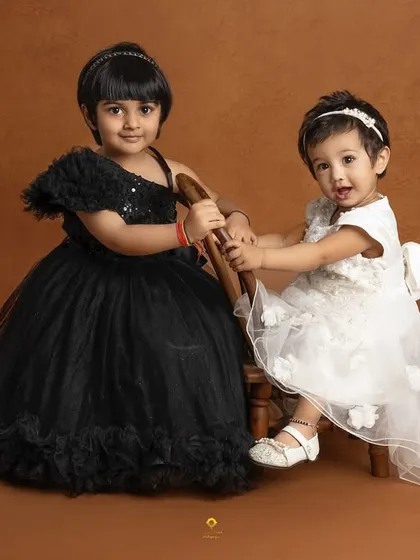 The sweet bond between sisters is a story I love to tell. In this simple studio portrait, their connection shines through, creating a memory their family will cherish for a lifetime.