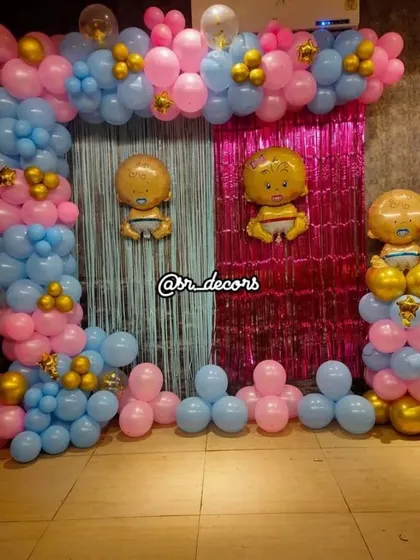 This is a fun setup for a gender reveal party or a baby shower celebrating twins. I use a split backdrop with blue and pink foil curtains and matching balloon arches, complete with baby boy and girl foil balloons to build excitement.