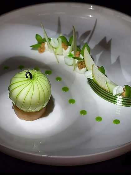 A finely crafted dish of thinly sliced cucumber wrapped around a filling. This is an example of the intricate and delicate food art our chefs can create.