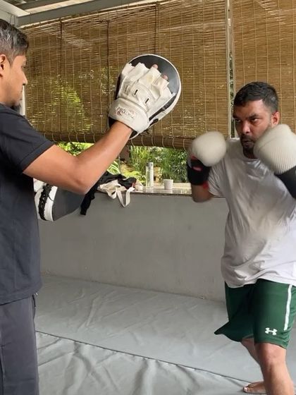 Two members trading punches and working on their boxing technique.