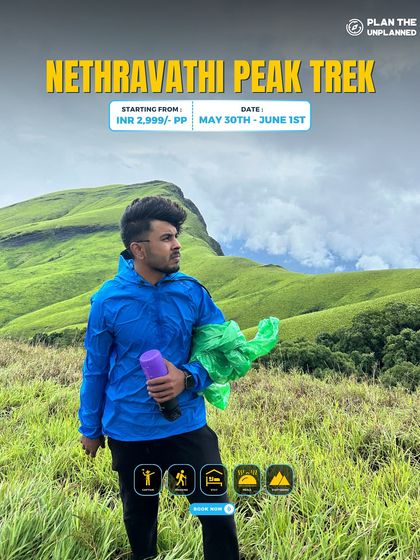 A trekker on the Netravathi Peak trail, surrounded by lush greenery.