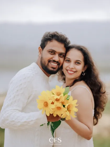 A bright and happy portrait of the couple with a bouquet of sunflowers. Their genuine smiles make this a heartwarming and cheerful image.