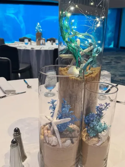 Another view of the elegant underwater centerpieces, set against the backdrop of a large aquarium, enhancing the theme even further.