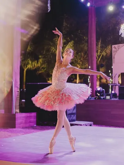 A graceful ballerina performs on stage, adding an element of classic European artistry and elegance to the Parisian theme.