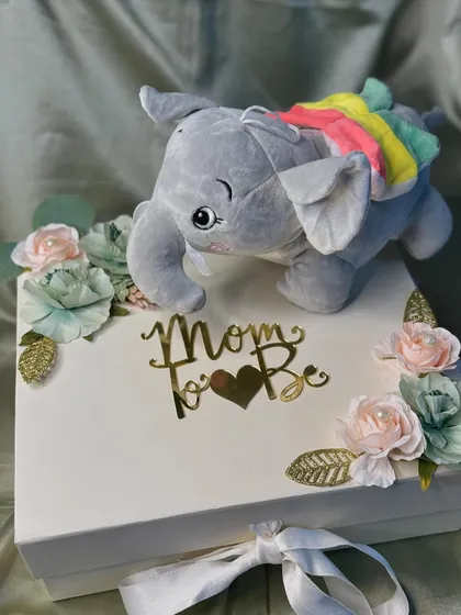 Pampering love for the mom-to-be. This elegant gift box is personalized for her and includes a cute elephant soft toy, perfect for a baby shower gift.