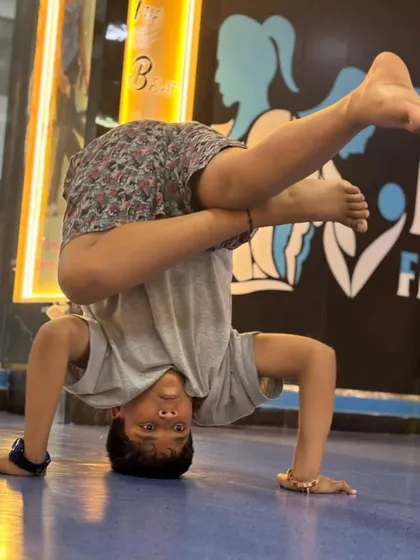 We help kids discover their strength and coordination through dynamic movements. This student is mastering a challenging breakdance freeze, building core strength and confidence on our matted studio floor.