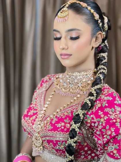 A side profile showcasing the elegant hairstyle and the soft, shimmery makeup.