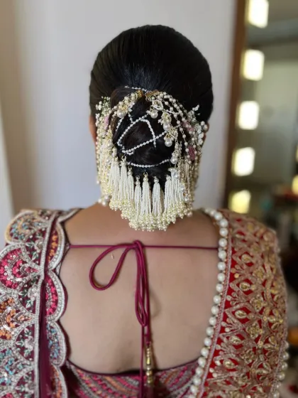 A stunning bridal hair accessory with pearl tassels, creating a very grand and traditional look for the main wedding day.