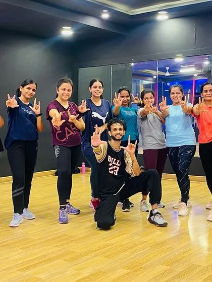 Say hello to our amazing Zumba family. This is what it's all about: sweating it out, smiling, and making new friends. Our instructor Akshay poses with the squad after a killer session.