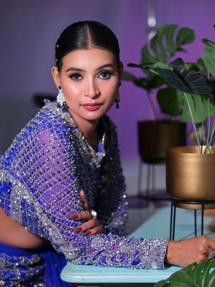 A candid, relaxed pose that still exudes glamour, showing how our makeup looks beautiful from every angle.