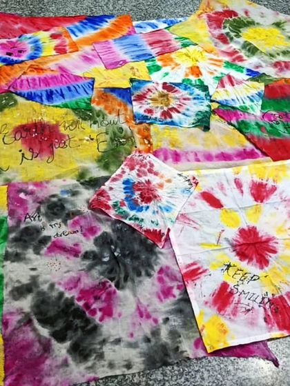 A colorful array of finished tie-dye pieces from one of our workshops. Each piece is unique, reflecting the creativity of its maker.