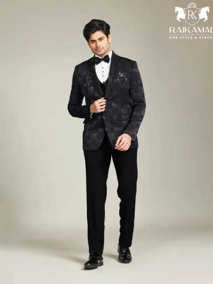 A bespoke tuxedo is the ultimate statement of class. This full-length shot shows the impeccable fit and sharp silhouette of a custom-patterned black three-piece suit, designed for black-tie events or a sophisticated groom's reception look.