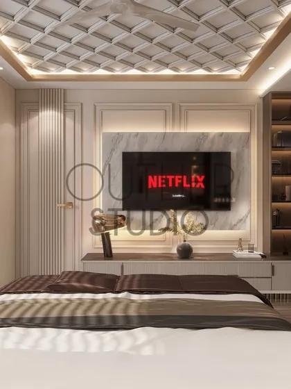 This angle of the master suite shows the view from the bed towards the media wall. The design incorporates classic wall mouldings and a stunning coffered ceiling for a touch of timeless elegance.