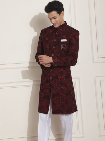 A deep maroon Indo-Western achkan with a subtle pattern. This lightweight yet classy outfit is a great option for a best friend's wedding events.