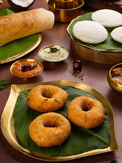 A focus on the crispy, golden medu vadas. The styling is simple and clean, letting the texture and shape of this popular South Indian snack shine.
